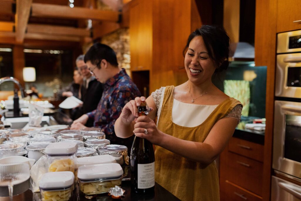 A bride and her husband cook food for their family on their wedding day in Mammoth Lakes. 
