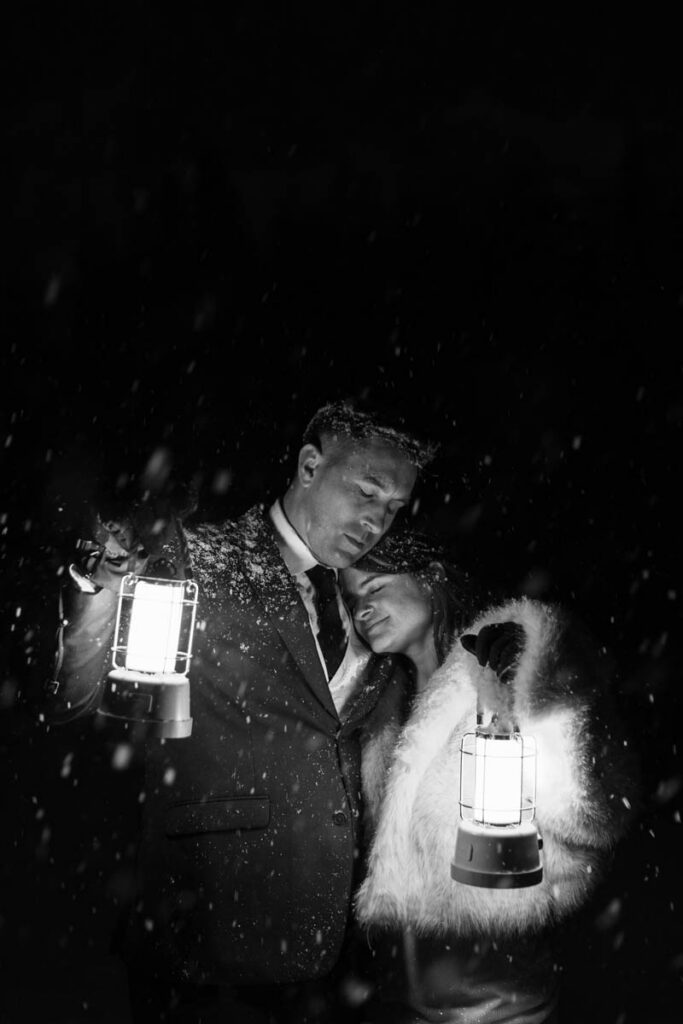 A newly married couple embraces by lantern light on their wedding day in Mammoth Lakes.