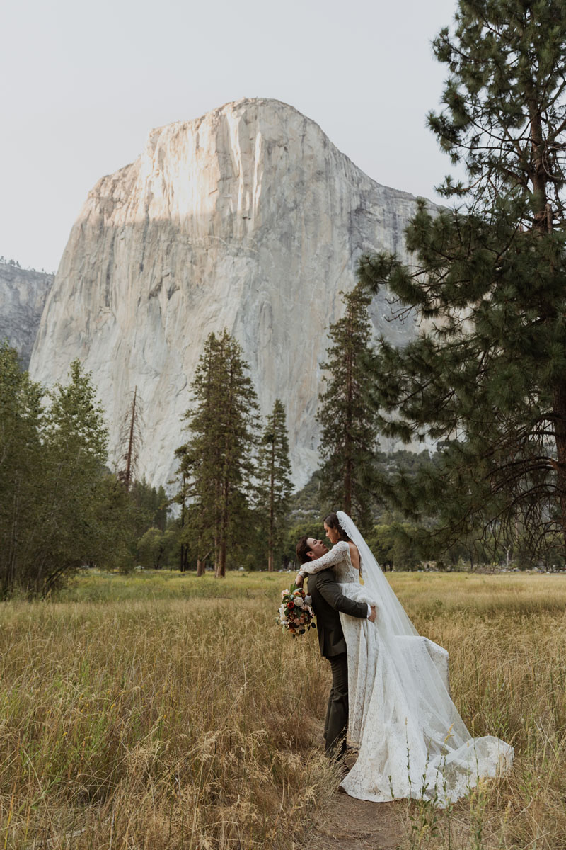 A couple kisses on their wedding day in front of El Capitan in Yosemite National Park.